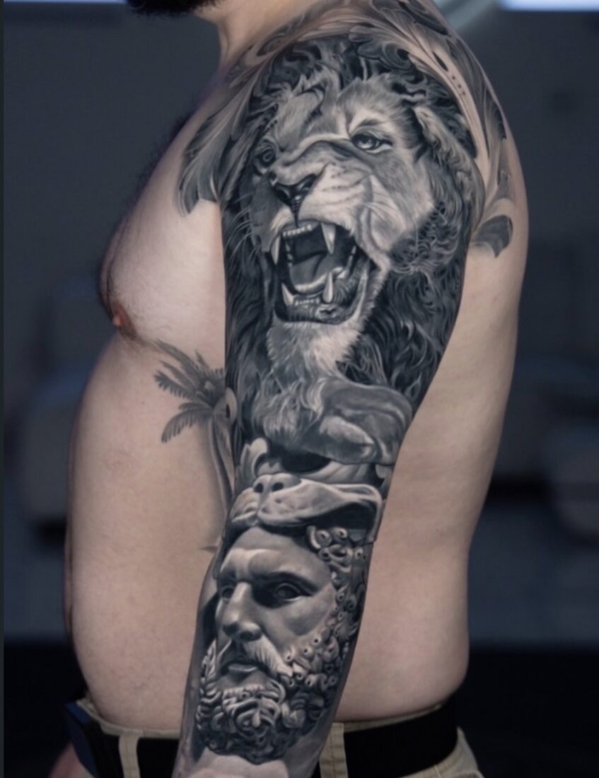 Black and grey realism lion and statue sleeve by Robert Pho